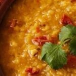 Bowl of Turkish red lentil soup garnished with fresh herbs and lemon, a heart-healthy recipe for blood pressure support