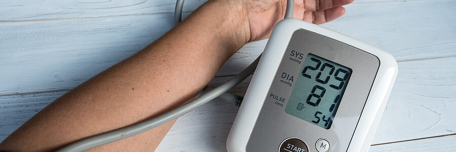 Man checking blood pressure at home.