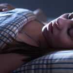 Person in deep restorative sleep at night supporting healthy blood pressure
