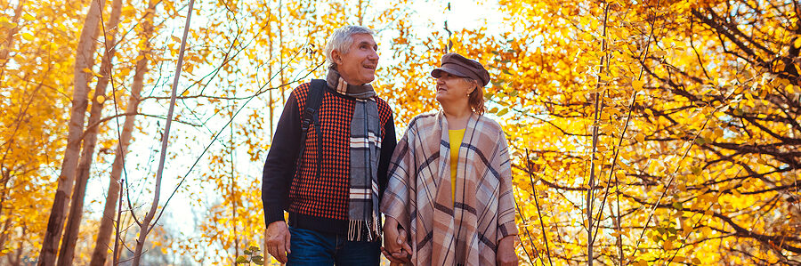 senior couple walking in the woods