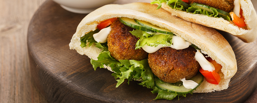 a pita bread sandwich with Falafel and vegetables