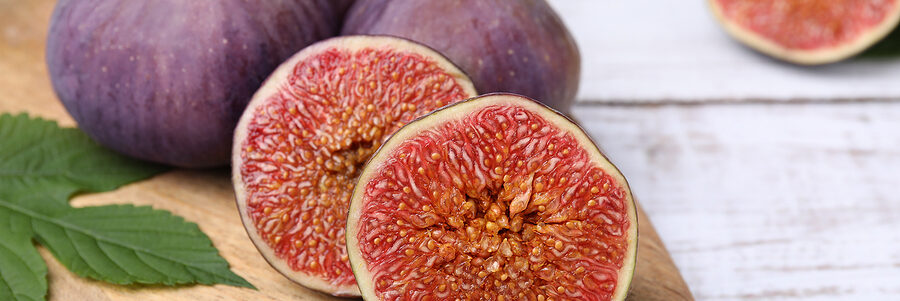 a group of figs on a wooden surface