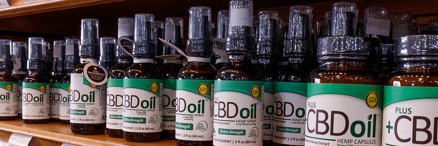 a shelf with bottles of cbd oil