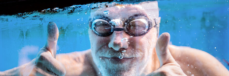 a person in goggles and swimming goggles in a pool
