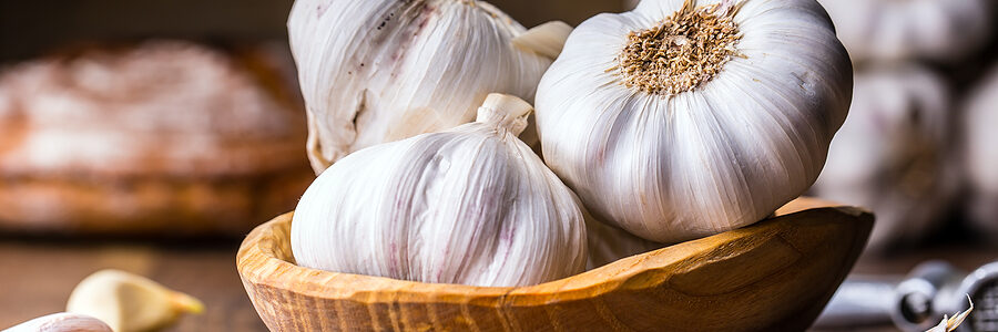 a bowl of garlic and cloves